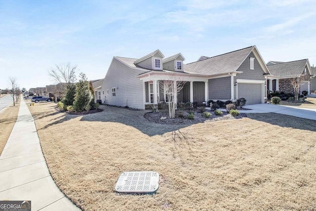 view of front of property featuring covered porch and a garage