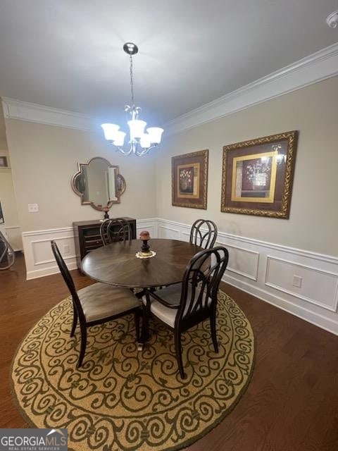 dining room with an inviting chandelier, dark hardwood / wood-style floors, and ornamental molding