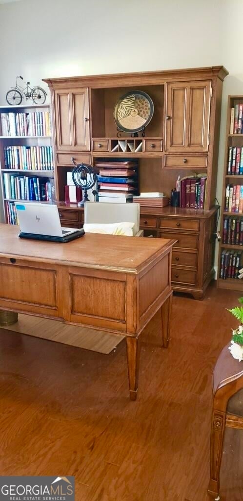 interior space featuring built in desk and dark wood-type flooring