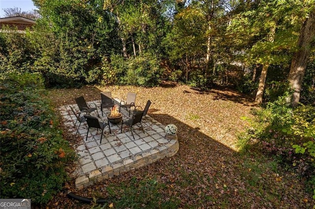 view of yard featuring a patio and a fire pit