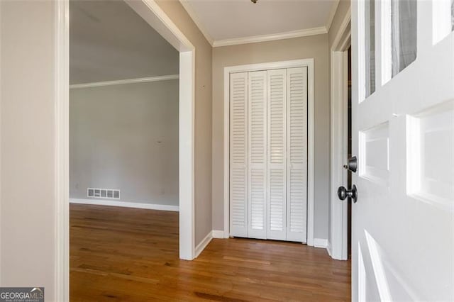 hallway with dark hardwood / wood-style flooring and ornamental molding