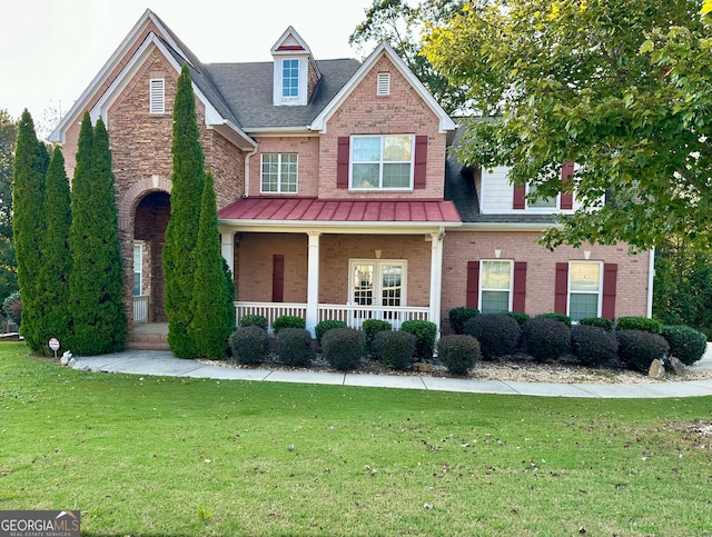 view of front of house with a porch and a front yard