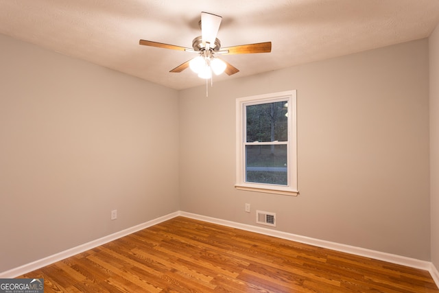 spare room featuring ceiling fan and hardwood / wood-style flooring