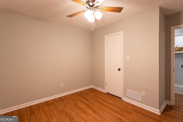 unfurnished bedroom with ceiling fan and light wood-type flooring