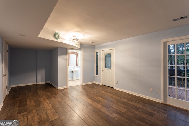 unfurnished room featuring dark wood-type flooring