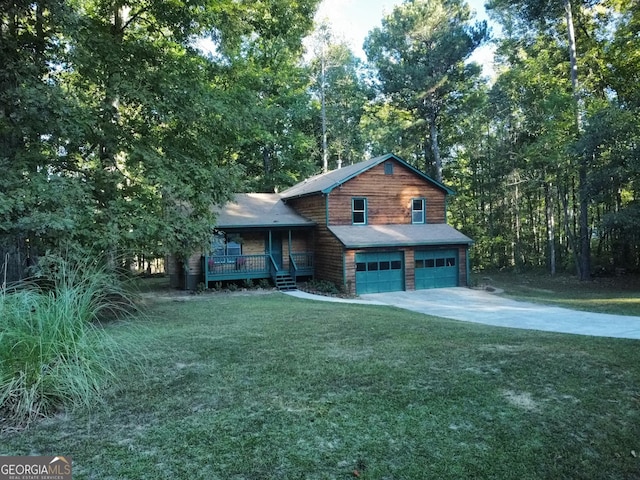 view of front of house featuring a front lawn, a garage, and a porch