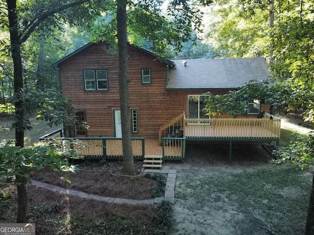 rear view of house with a wooden deck