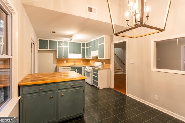 kitchen with wooden counters, sink, white appliances, green cabinets, and hanging light fixtures