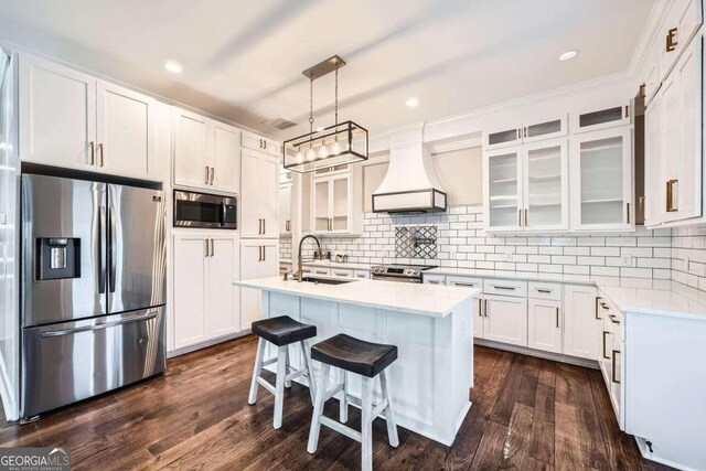 kitchen with custom exhaust hood, sink, dark hardwood / wood-style floors, appliances with stainless steel finishes, and white cabinetry