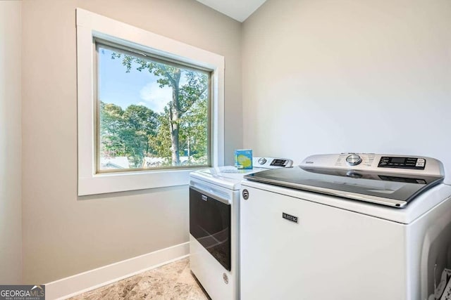 washroom featuring washer and clothes dryer