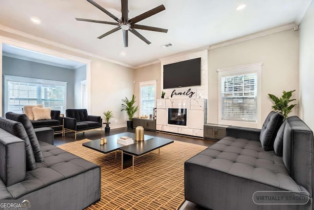 living room with ornamental molding, a healthy amount of sunlight, and hardwood / wood-style floors