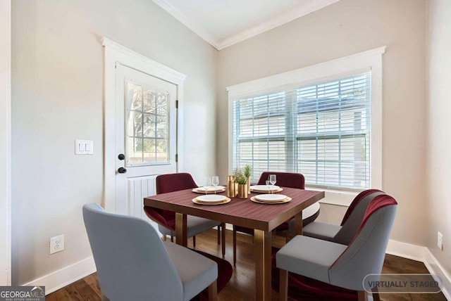 dining space featuring dark wood-type flooring and ornamental molding