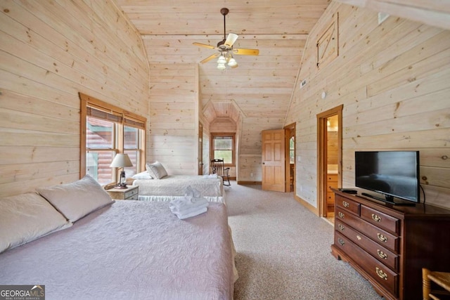 bedroom featuring light carpet, wood ceiling, ceiling fan, wooden walls, and connected bathroom