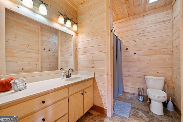 bathroom featuring a shower with curtain, vanity, wooden walls, wooden ceiling, and toilet