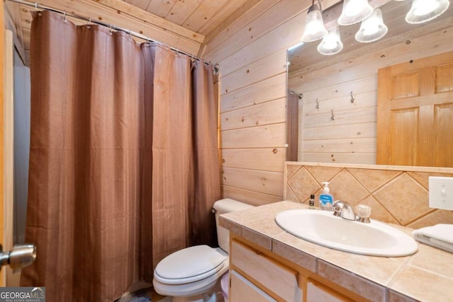 bathroom with vanity, wood walls, toilet, and wood ceiling