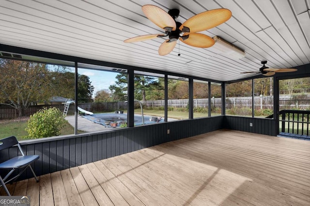 unfurnished sunroom featuring ceiling fan and wood ceiling