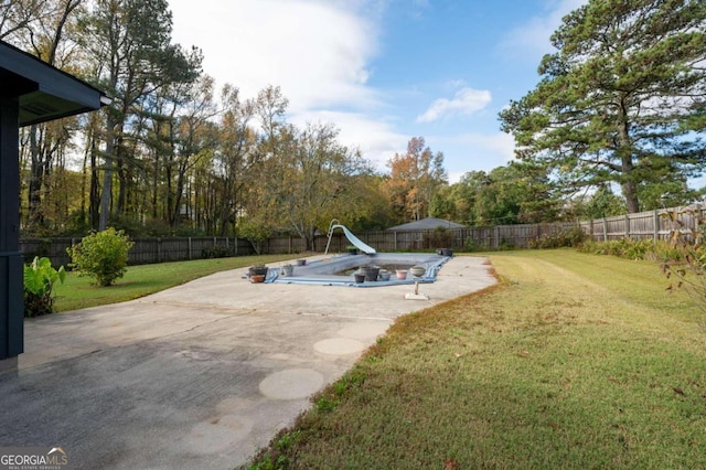 view of swimming pool featuring a lawn and a water slide