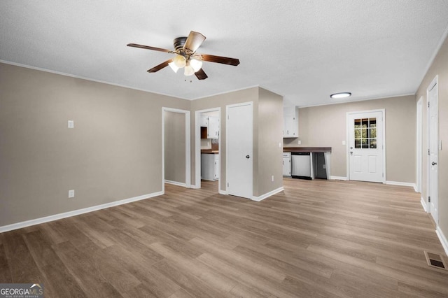 unfurnished living room with ceiling fan, a textured ceiling, and light hardwood / wood-style flooring