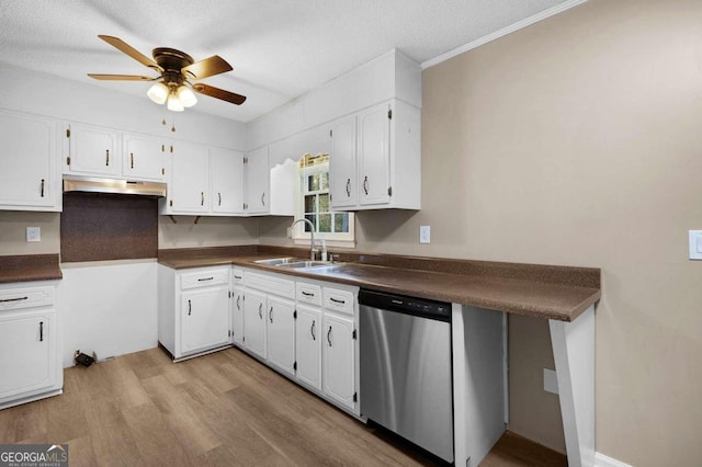 kitchen featuring stainless steel dishwasher, white cabinets, light wood-type flooring, and sink