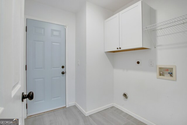 laundry room featuring cabinets, hookup for a washing machine, light hardwood / wood-style flooring, and electric dryer hookup