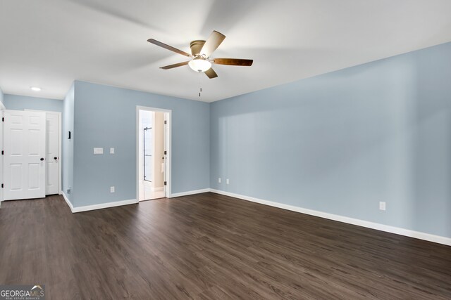 empty room with dark hardwood / wood-style floors and ceiling fan