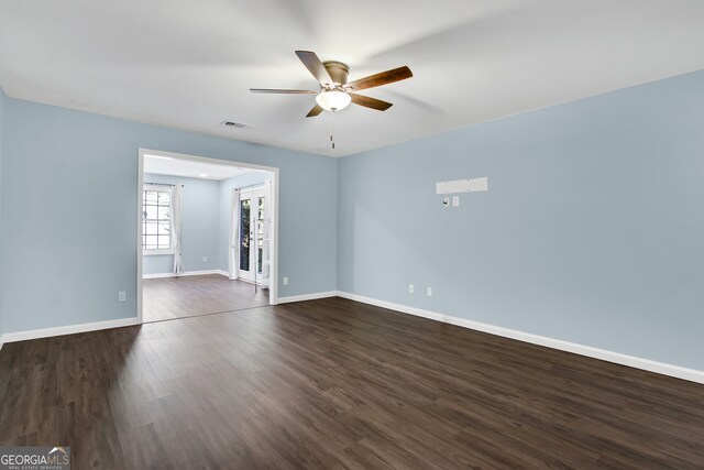 unfurnished room with ceiling fan, dark hardwood / wood-style flooring, and french doors