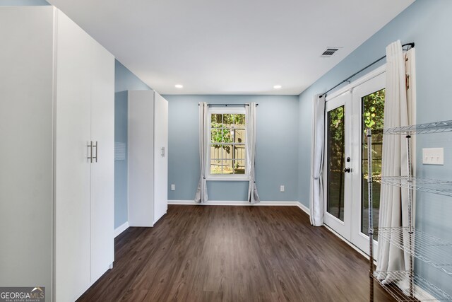 spare room with french doors and dark hardwood / wood-style floors