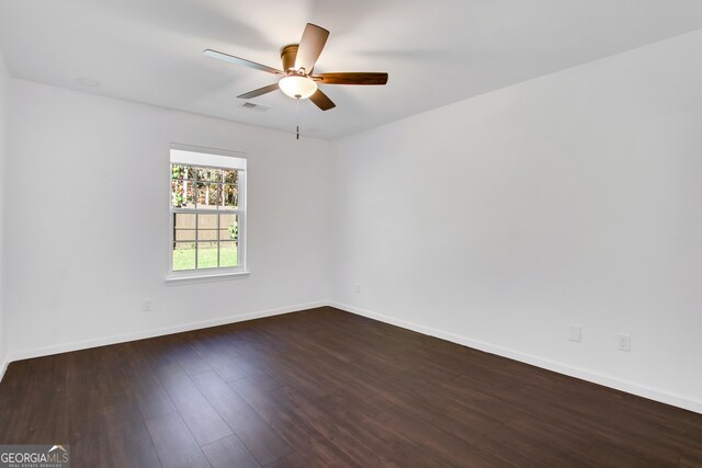 unfurnished room with ceiling fan and dark hardwood / wood-style flooring