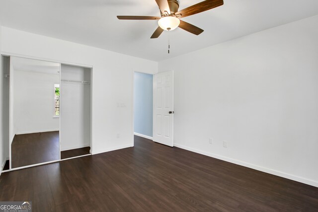 unfurnished bedroom with ceiling fan, a closet, and dark hardwood / wood-style floors