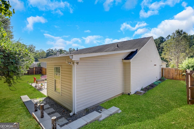 view of home's exterior featuring a yard and a patio