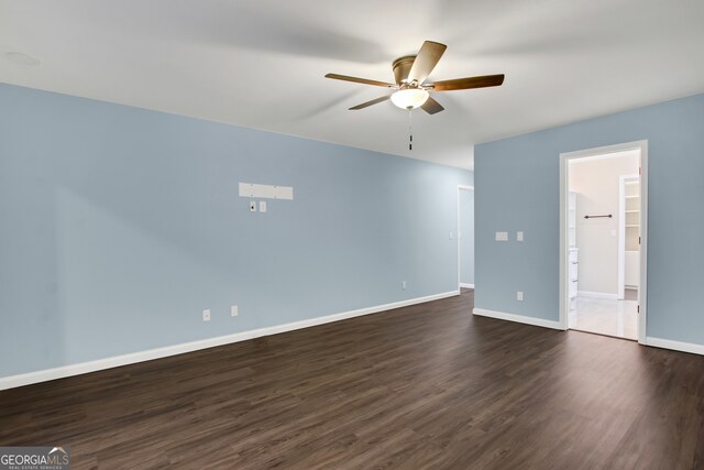 empty room featuring ceiling fan and dark hardwood / wood-style flooring