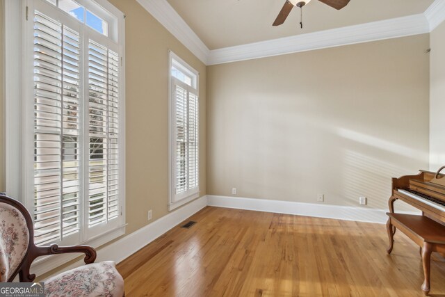 sitting room featuring ceiling fan, ornamental molding, and light hardwood / wood-style flooring