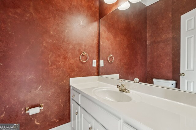 bathroom with vanity and toilet