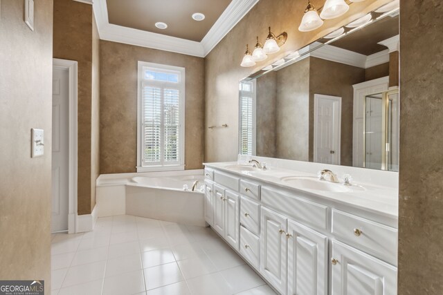 bathroom with tile patterned floors, crown molding, vanity, and a bath