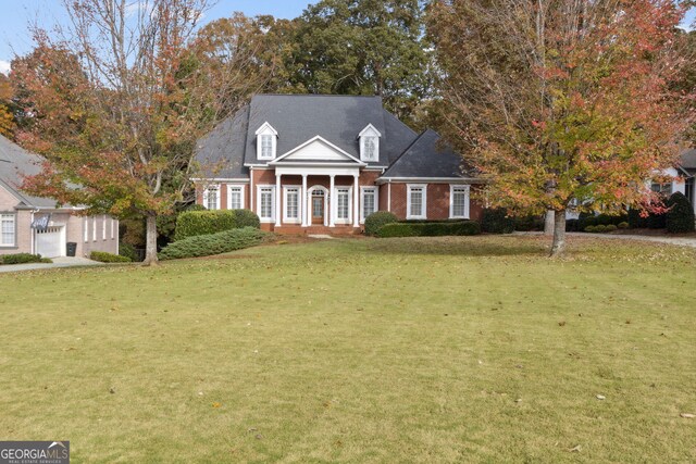 new england style home featuring a front yard