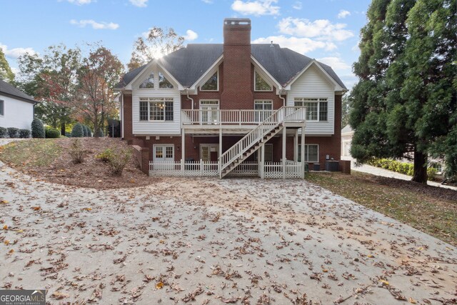 rear view of house with central air condition unit and a wooden deck