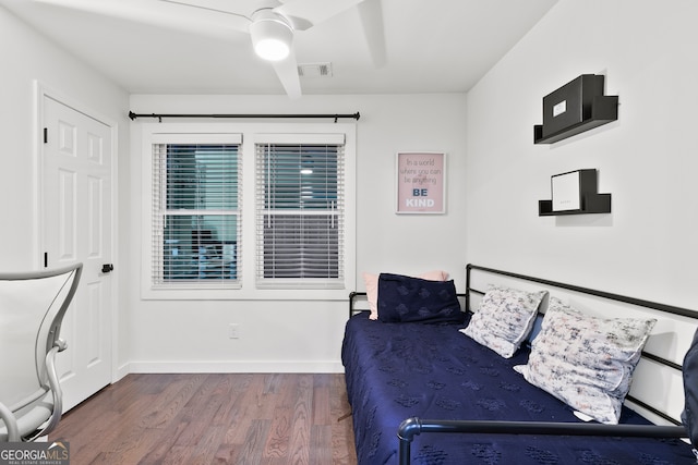 bedroom with ceiling fan and dark hardwood / wood-style flooring