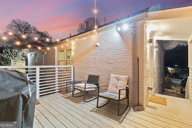 deck at dusk with area for grilling