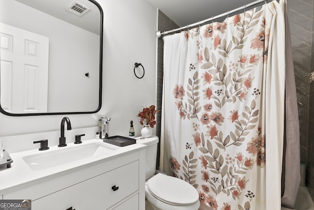 bathroom with vanity, toilet, and walk in shower