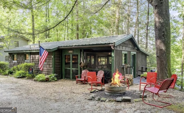 view of outdoor structure featuring an outdoor fire pit