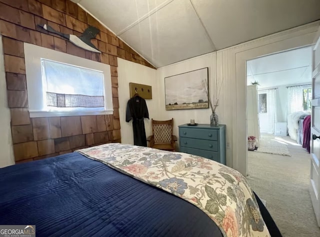 bedroom with carpet, vaulted ceiling, and wooden walls