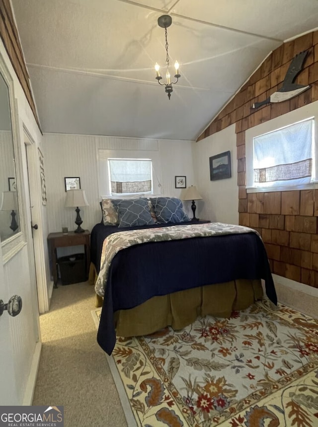 carpeted bedroom featuring wood walls, a chandelier, and lofted ceiling