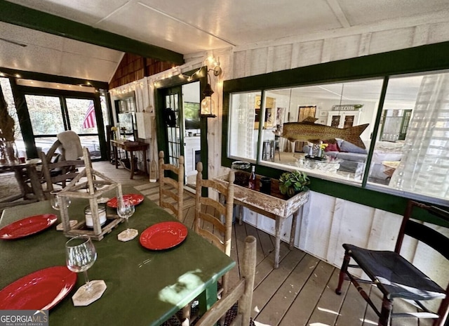 dining room with wood-type flooring and lofted ceiling