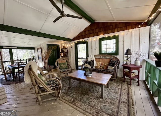 sunroom with vaulted ceiling, a wealth of natural light, and ceiling fan