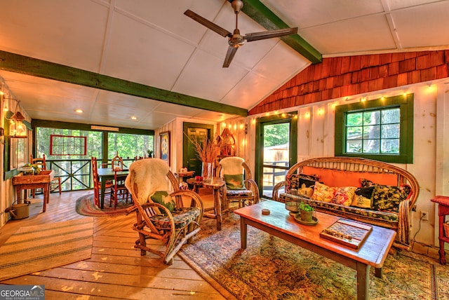 living room featuring wood-type flooring, ceiling fan, lofted ceiling, and wood walls