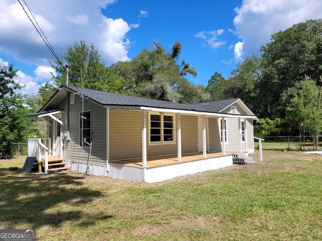 back of property featuring a lawn