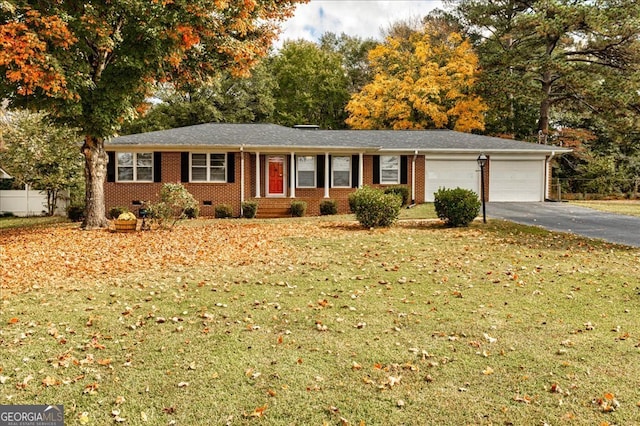 single story home featuring a garage and a front lawn