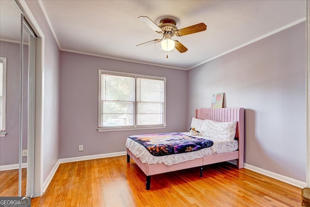 bedroom featuring wood-type flooring, ceiling fan, and ornamental molding