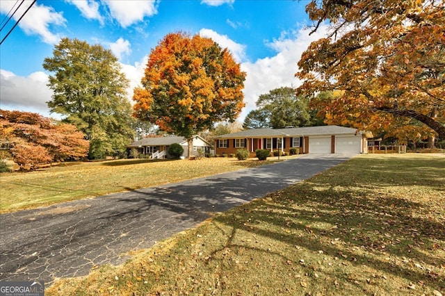 ranch-style home featuring a garage and a front yard