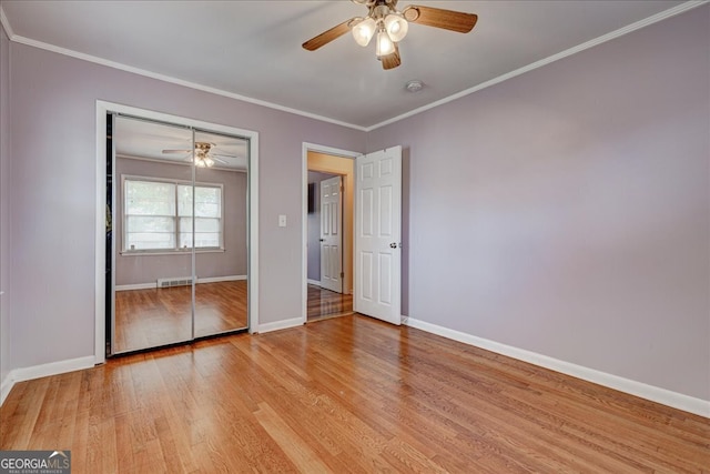 unfurnished bedroom with a closet, light hardwood / wood-style floors, ceiling fan, and ornamental molding